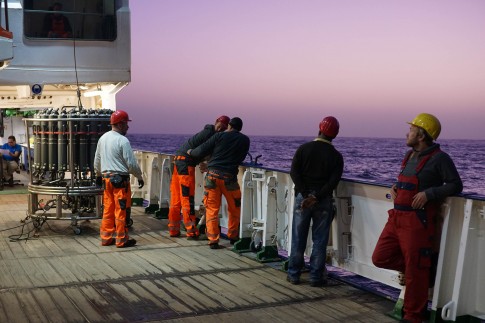 Figure 2. The crew and scientists assemble for a CTD cast at dusk. 