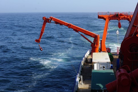 Figure 1. The towed fish surface water sampler leaves a wake in the clear blue south Atlantic.