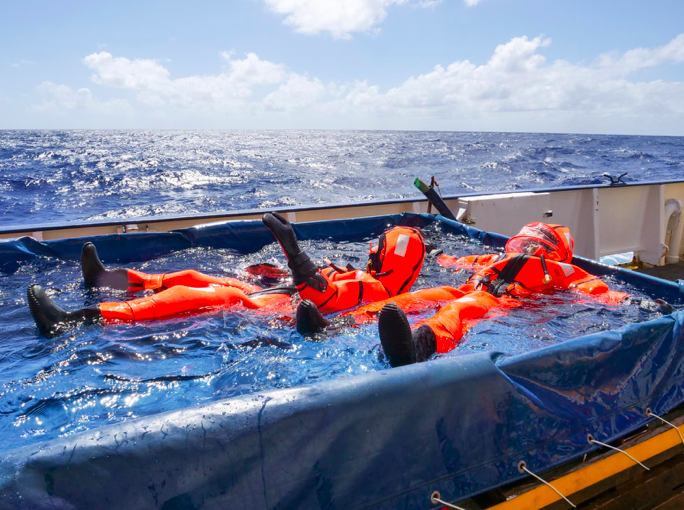 Two people on survival suits in a pool onboard RV METEOR. Photo by Martin Visbeck