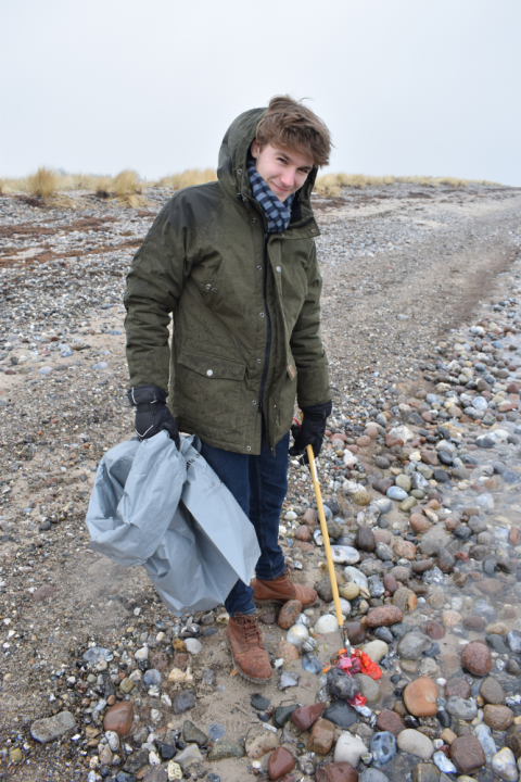 Lukas Pott, FÖJ-ler der Kieler Forschungswerkstatt, findet große Plastikteile direkt an der Wasserkante. Vermutlich wären diese ohne unser Sampling wohl in die Ostsee gelangt. Foto: Dennis Brennecke