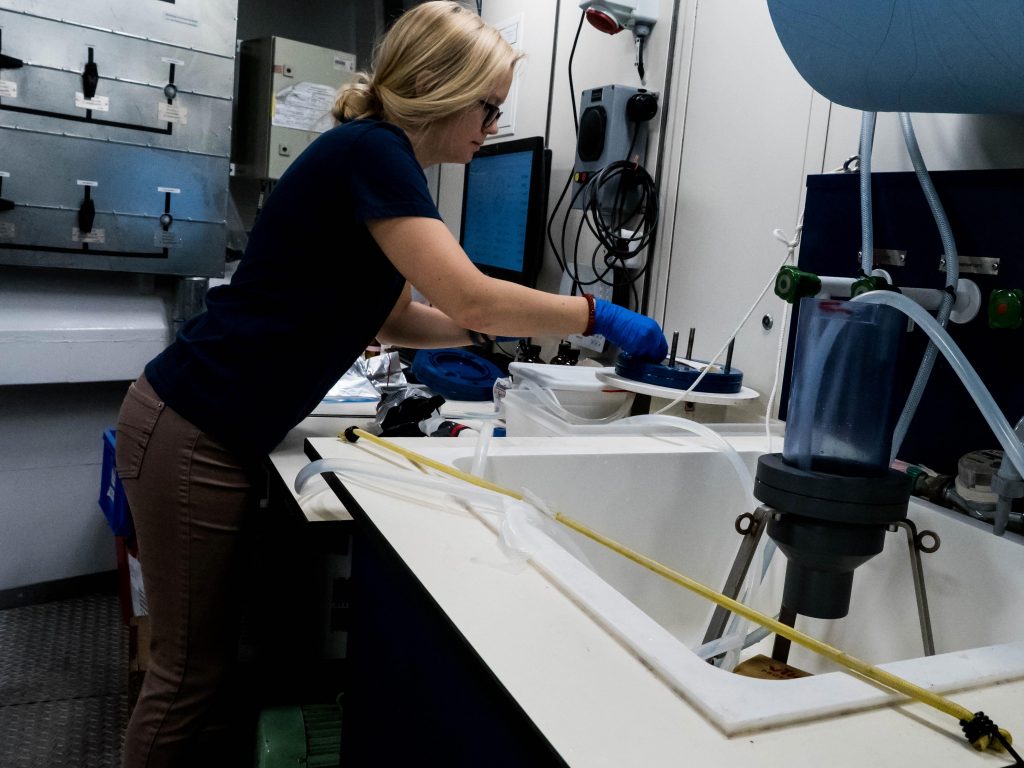 A scientist removing the sample from the seawater filtration system. Photo: Steffen Niemann