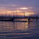 Indonesia sun rise: Bamboo constructions in Jakarta Bay