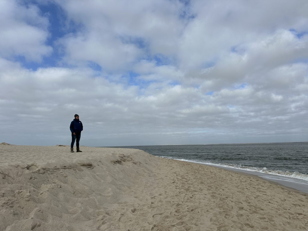 A woman at the beach watching over the sea