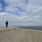 A woman at the beach watching over the sea