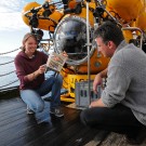 Janina Büscher and Dr. Armin Form, GEOMAR, with cage for in-situ growth experiments with cold-water coral Lophelia pertusa. Photo: Maike Nicolai, GEOMAR